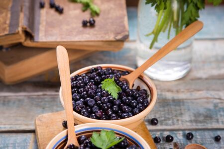 fresh bilberry with green parsley in crockery dishの写真素材