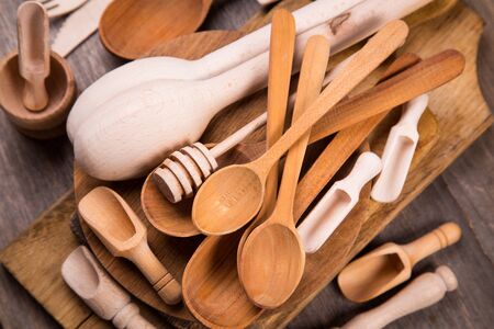 some wooden kitchen utensil in studio on wooden backgroundの写真素材