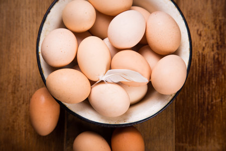 many fresh healthy brown eggs in old blue dish