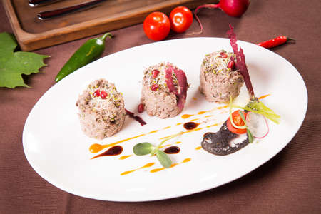 duck pate with sauce on white plate in restaurantの写真素材