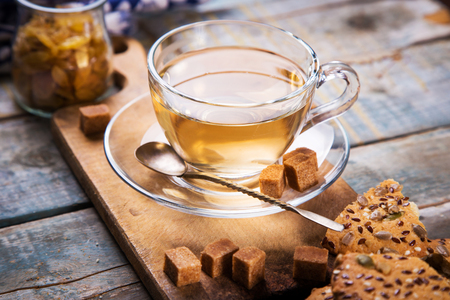 tea in transparent cup with biscuit cookie on wooden backgroundの写真素材