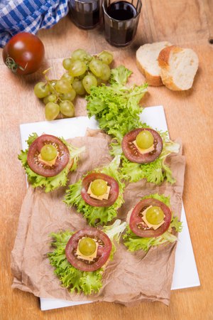 tasty vegetarian canape with grape,cheese and lettuceの写真素材