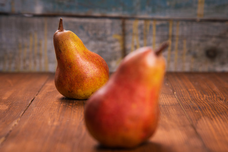 two delicious raw ripe pears on wooden backgroundの写真素材