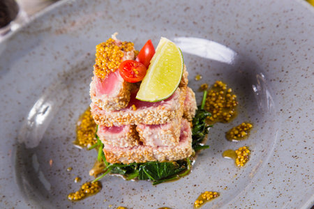 fresh tuna on spinach with tomato and citrus in grey dishの写真素材