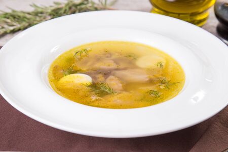 hot fresh soup with chicken meat,egg and dill in white plateの写真素材