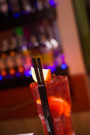 an alcoholic cocktail is in beautiful glass, in the restaurantの写真素材