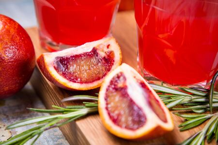 fresh squeezed juice of red citrus fruit with rosemaryの写真素材