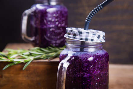 fresh smoothie drink from violet cabbage with green rosemaryの写真素材