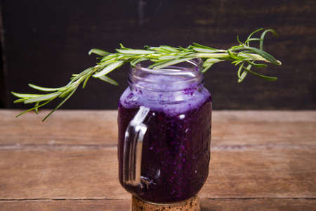 fresh smoothie drink from violet cabbage with green rosemaryの写真素材