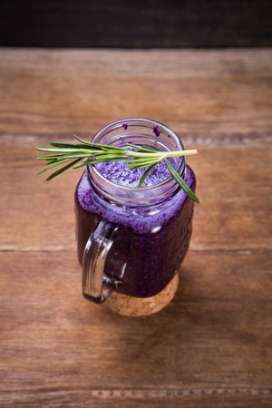 fresh smoothie drink from violet cabbage with green rosemaryの写真素材