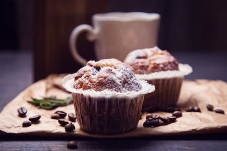 hot fresh coffee in white cup with muffin and rosemaryの写真素材