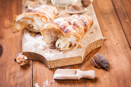 fresh crust croissant with milk on wooden plateの写真素材