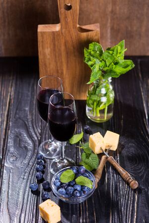 two glass with red vine,cheese,blueberry and mintの写真素材