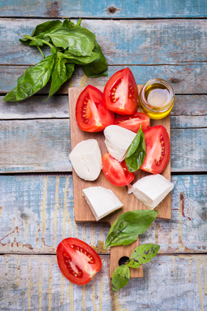 ingredients for caprese salad-fresh tomatoes and mozzarellaの写真素材