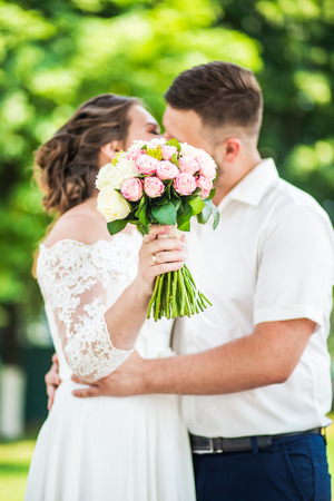Bride and groom holding the elegance wedding bouquetの写真素材