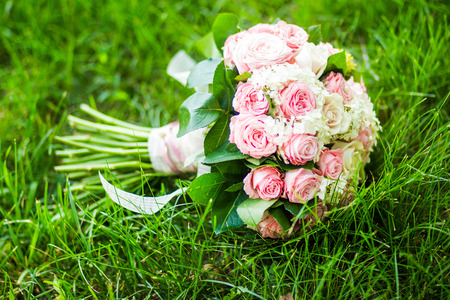 Wedding bouquet.Elegance bouquet with roses on green grassの写真素材