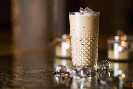 Refreshing cold frappe coffee with ice in restaurantの写真素材