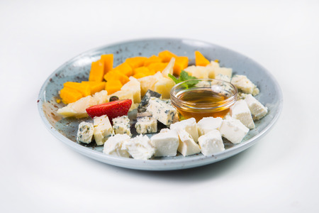 cheese plate with oil,strawberry and mint isolated on whiteの写真素材