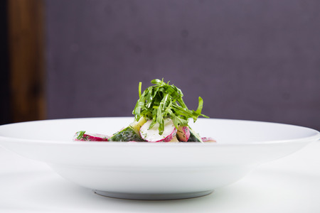 salad with cucumber, green onion, sour cream, arugula, radish, cherry tomatoesの写真素材