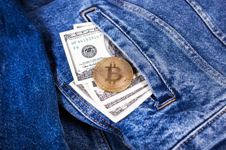 symbol of bitcoin and american dollars in jeans pocketの写真素材