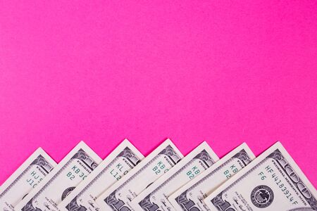 some dollars of america isolated on pink background in studioの写真素材