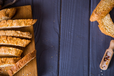 Crispy salted bread, scoop with salt crystalls on wooden table. Salty junk, unhealthy snacks, fast carbohydrates food.の写真素材