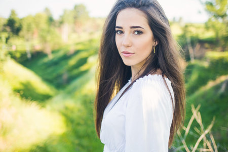 portrait of a beautiful young girl, outdoors, in the field