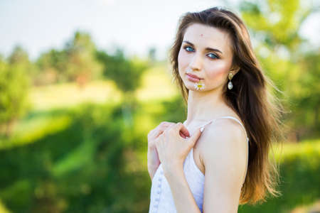 portrait of a beautiful young girl, outdoors, in the fieldの写真素材