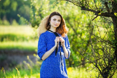portrait of a beautiful young girl, outdoors, in the fieldの写真素材