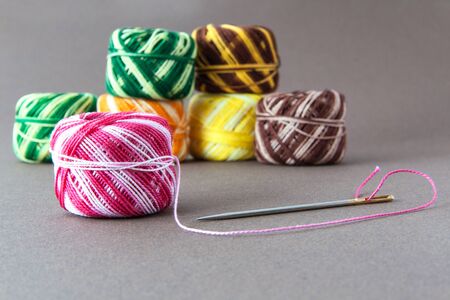 Group of spools of thread cross stitch With threaded needleの写真素材