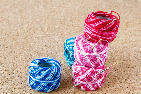 Three spools of thread form a tower and blue two coils