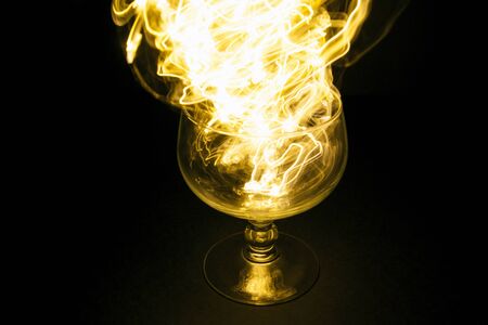 Cup in the dark with fire flameの写真素材