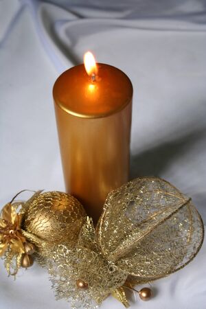 Lighted Candle and Christmas Decorationの写真素材