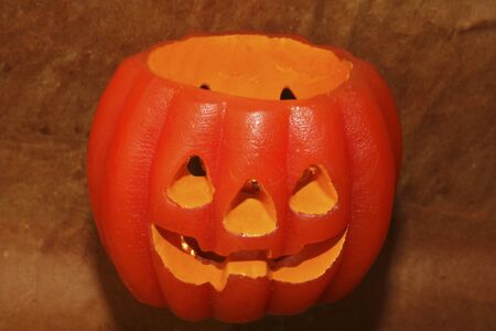 Strong orange halloween pumpkin on a brown background.の写真素材