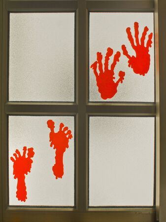 In Halloween decoration hands and feet on a kitchen window.の写真素材