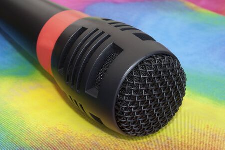 Karaoke microphone on top of a colorful background.の写真素材