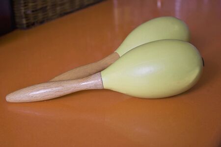 Two green maracas on a orange kitchen bar.の写真素材