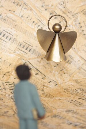 Boy and angel with a music sheet as backgroundの写真素材