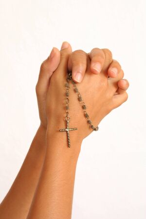 Hands of a girl with a rosary in a position of praying.の写真素材