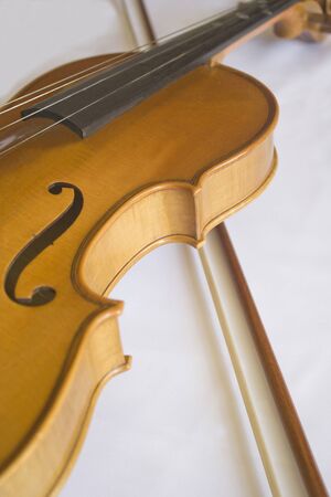 Close up off violin and bow in a white background.の写真素材