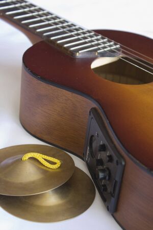 Close up of traditional guitar and small cymbals.の写真素材
