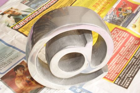 Grey symbol on top of several oriental newspapers.の写真素材