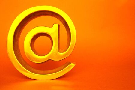 Isolated golden symbol in orange color back groundの写真素材