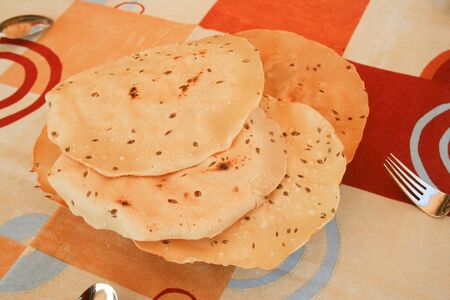 Some slices of papadum as appetizer to accompany the rest of the indian food.の写真素材