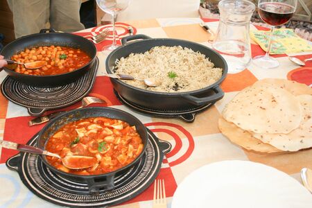 Plates of indian food and papadum for lunch.の写真素材