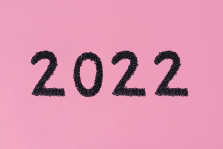 2022 New Year. Stone material number and pink background
