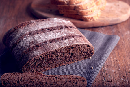 Sliced rye bread on a cutting board. Selective focus.