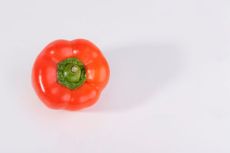 Red bell pepper isolated on white background. Top view. Copyspace.