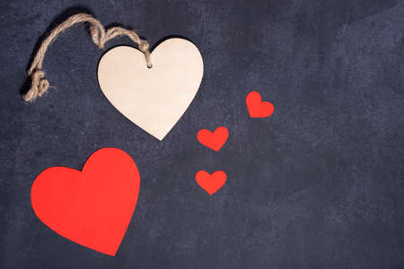 Red heart and wood heart, dark textured backgroundの写真素材