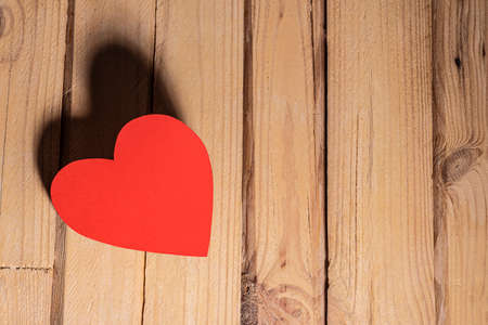 Red heart on a wooden tableの写真素材